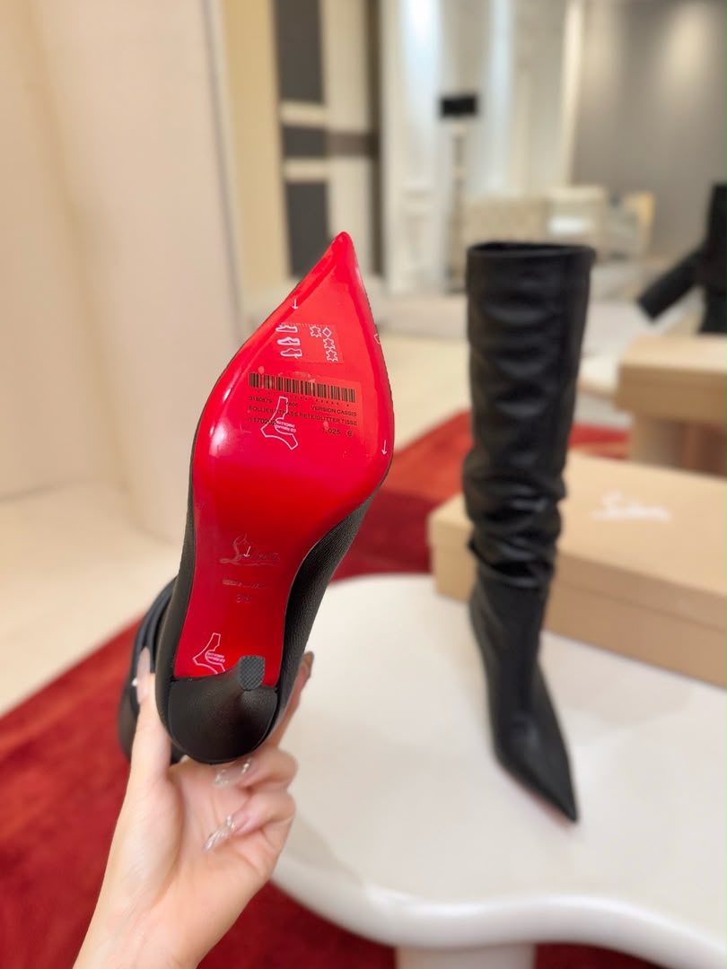 Iconic red-soled high-heeled boots